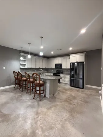 a kitchen with lots of counter top space and appliances