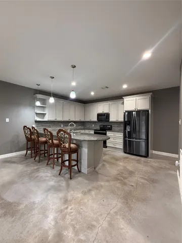 a kitchen with lots of counter top space and appliances