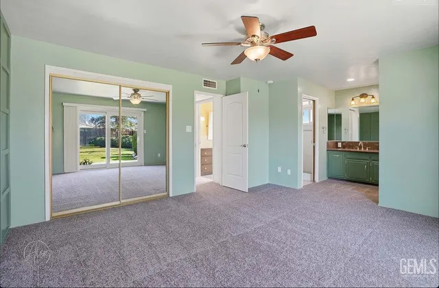 a view of a livingroom with a ceiling fan and window