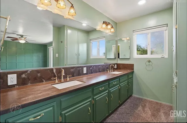 a bathroom with a double vanity sink and a mirror