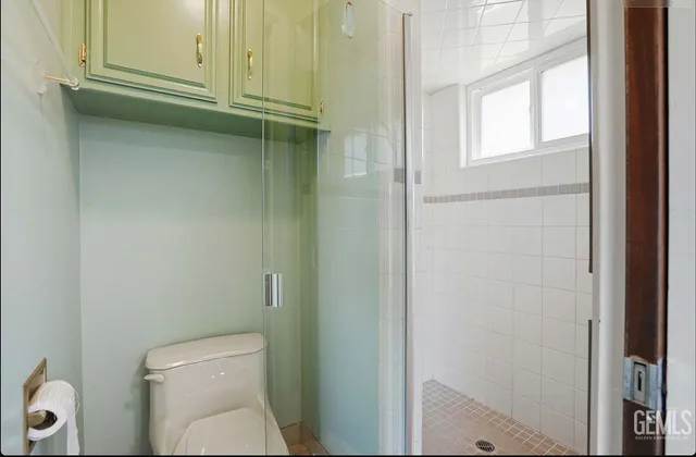 a bathroom with a toilet and a shower