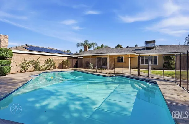a view of house with swimming pool outdoor seating
