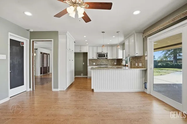 a view of a kitchen with a sink and refrigerator