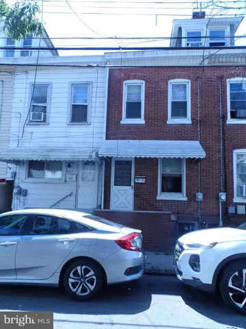 a front view of a house with parking space