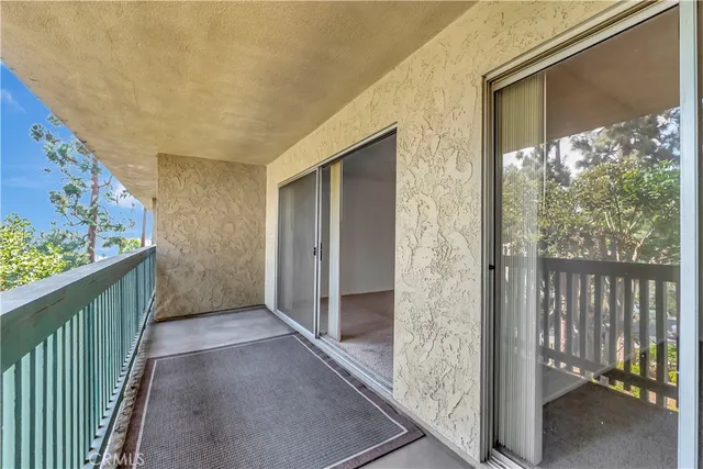 a living room with furniture a fireplace and a large window