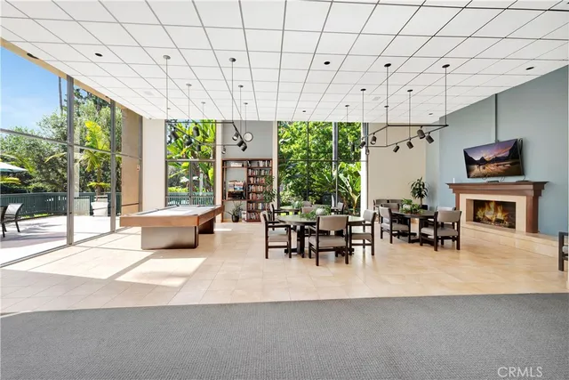 a living room with patio furniture and a fireplace