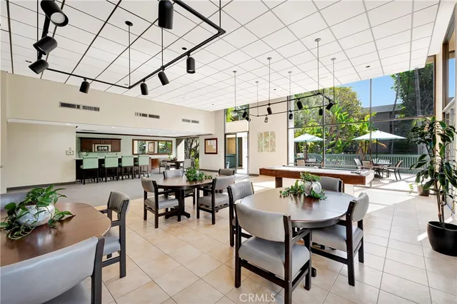 a view of a swimming pool with sitting area and furniture