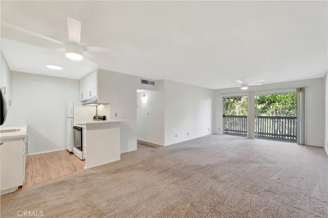 a view of a kitchen with a sink and a large window