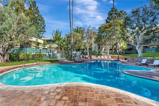 a view of a swimming pool with a patio and a garden