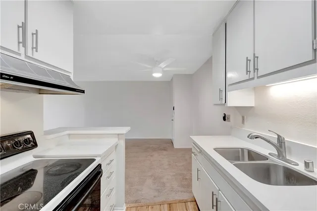 a kitchen that has a sink and a stove