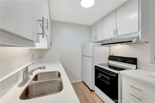 a kitchen with a sink and a stove top oven