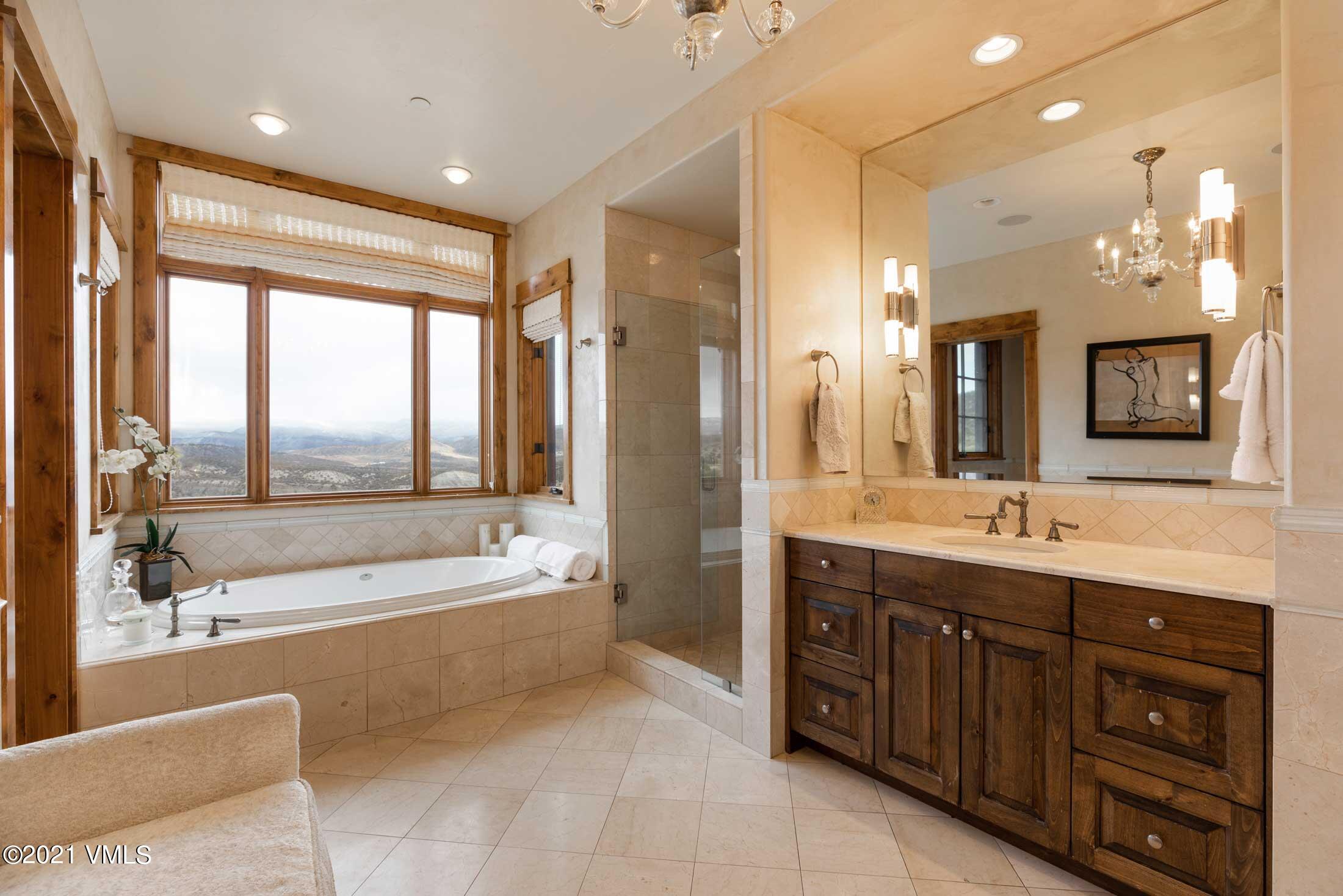 109 Juniper Trail Wolcott, CO 81655 - Photo 7 of 9 a spacious bathroom with a tub sink shower and mirror