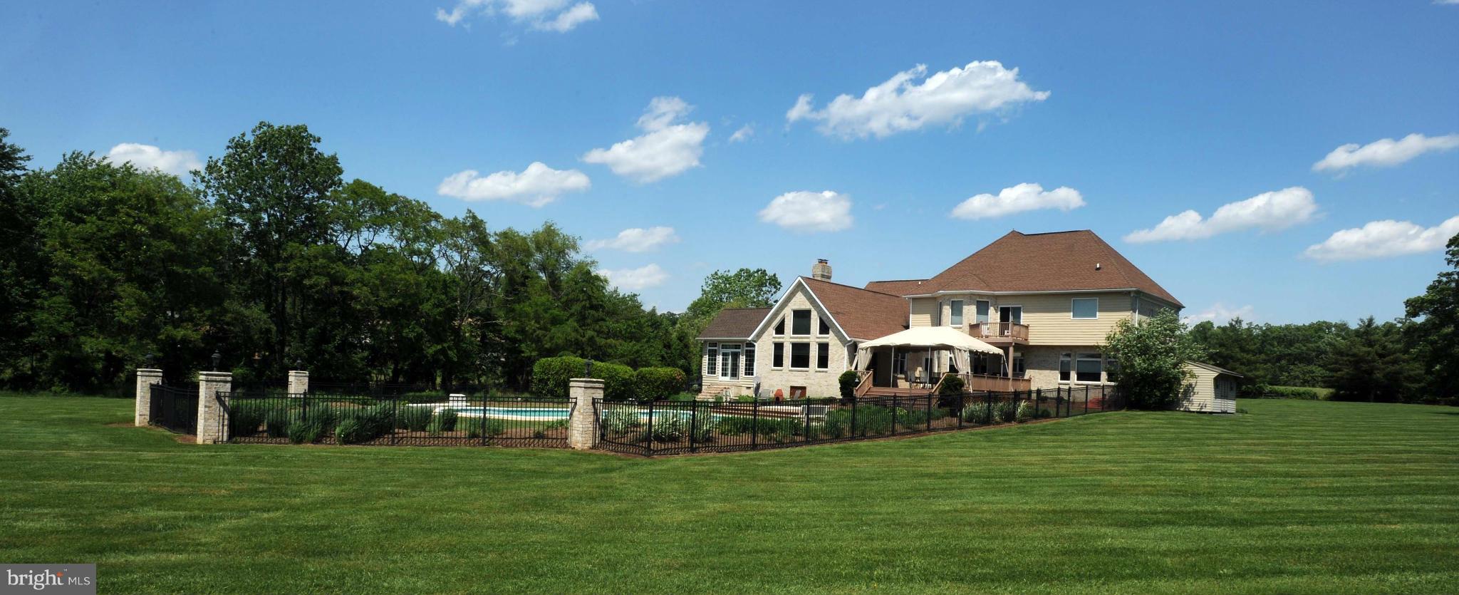 712 Connolly Farms Road Fallston, MD 21047 - Photo 7 of 30 a front view of a house with a garden and trees