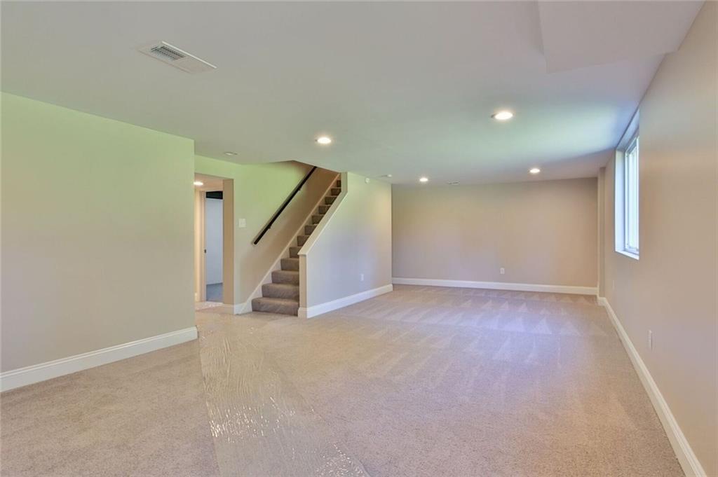 938 Bebout Road Venetia, PA 15367 - Photo 16 of 20 The large, fully renovated, basement is the perfect place for the kids to play or to set up your media room. It is detailed with recessed lights, new carpets, brick accented wood burning fireplace, and provides access to the rear yard, garage, utility room, bathroom, and laundry room.