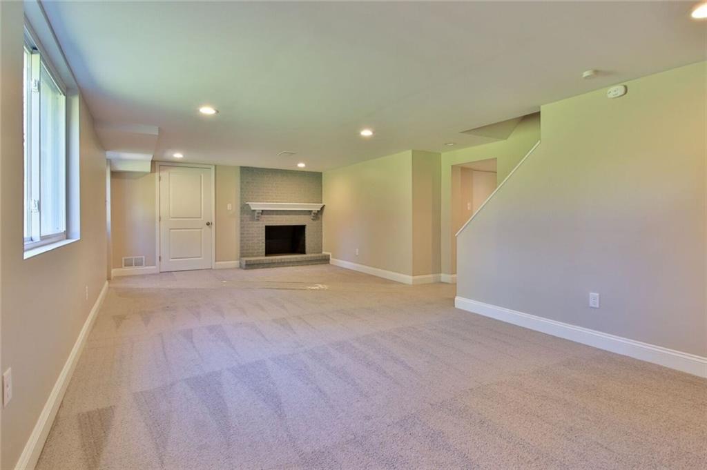 938 Bebout Road Venetia, PA 15367 - Photo 17 of 20 The large, fully renovated, basement is the perfect place for the kids to play or to set up your media room. It is detailed with recessed lights, new carpets, brick accented wood burning fireplace, and provides access to the rear yard, garage, utility room, bathroom, and laundry room.
