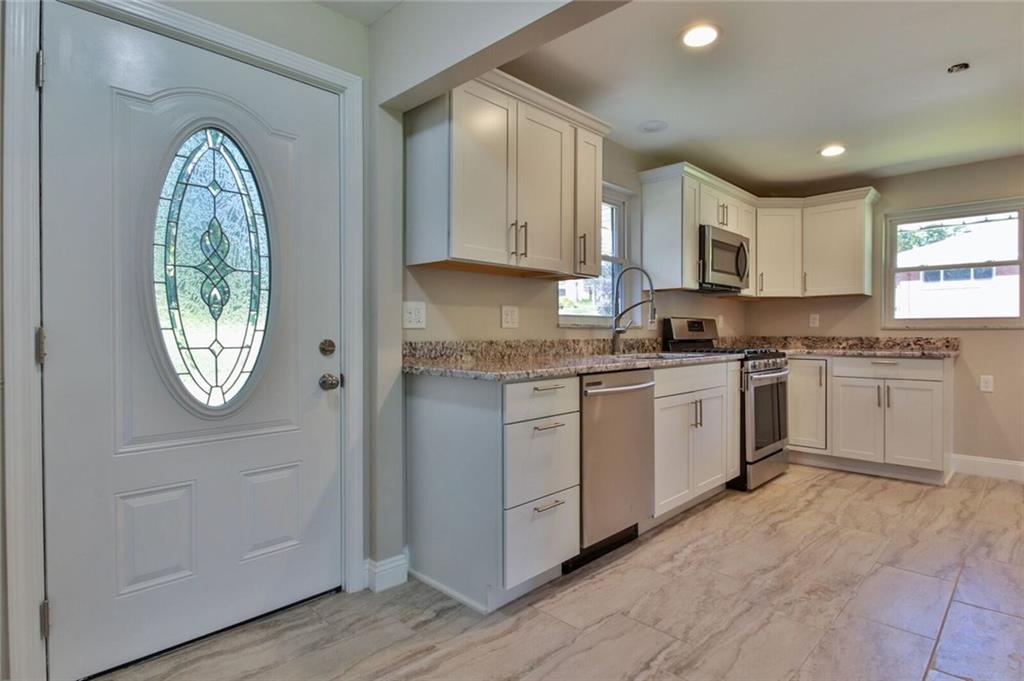 938 Bebout Road Venetia, PA 15367 - Photo 3 of 20 Upon entering the home you'll notice the beautifully designed kitchen with brand new hardwood cabinets, granite counter-tops and back-splash, stainless steel appliances, recessed lighting, and designer tile flooring.