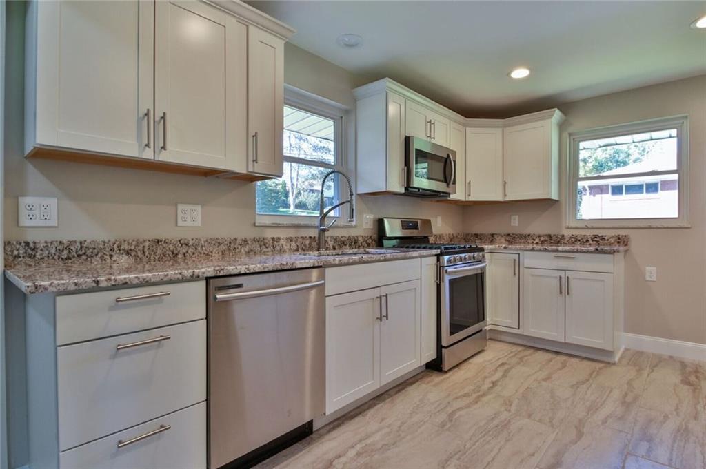 938 Bebout Road Venetia, PA 15367 - Photo 4 of 20 Beautifully designed kitchen with brand new hardwood cabinets, granite counter-tops and back-splash, stainless steel appliances, recessed lighting, and designer tile flooring.