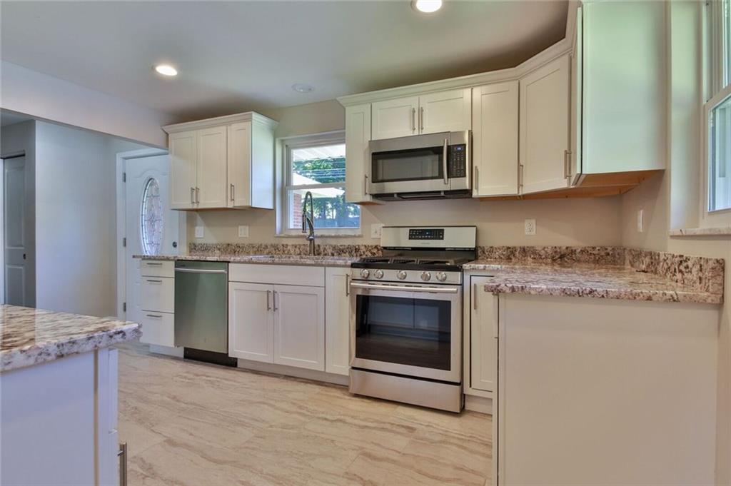 938 Bebout Road Venetia, PA 15367 - Photo 6 of 20 Beautifully designed kitchen with brand new hardwood cabinets, granite counter-tops and back-splash, stainless steel appliances, recessed lighting, and designer tile flooring.