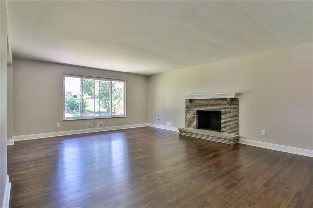938 Bebout Road Venetia, PA 15367 - Photo 7 of 20 The kitchen opens up into the large living area, with beautiful refinished hardwood floors and a natural stone accented wood burning fire place.