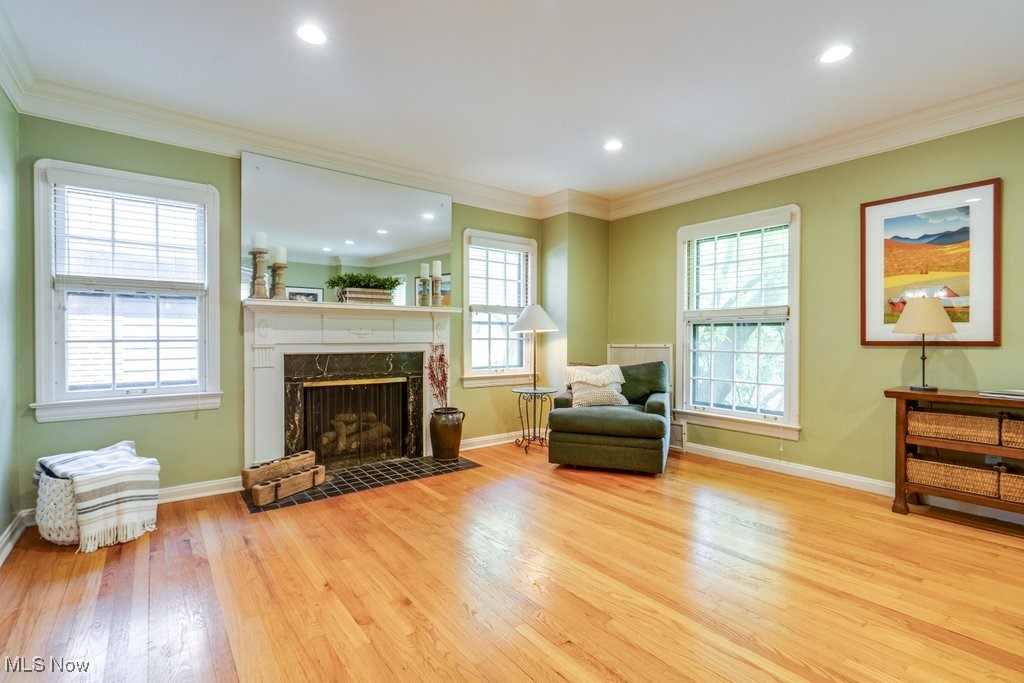 2500 Eaton Road Cleveland, OH 44118 - Photo 13 of 50 Living area featuring wood finished floors, a high end fireplace, baseboards, ornamental molding, and recessed lighting