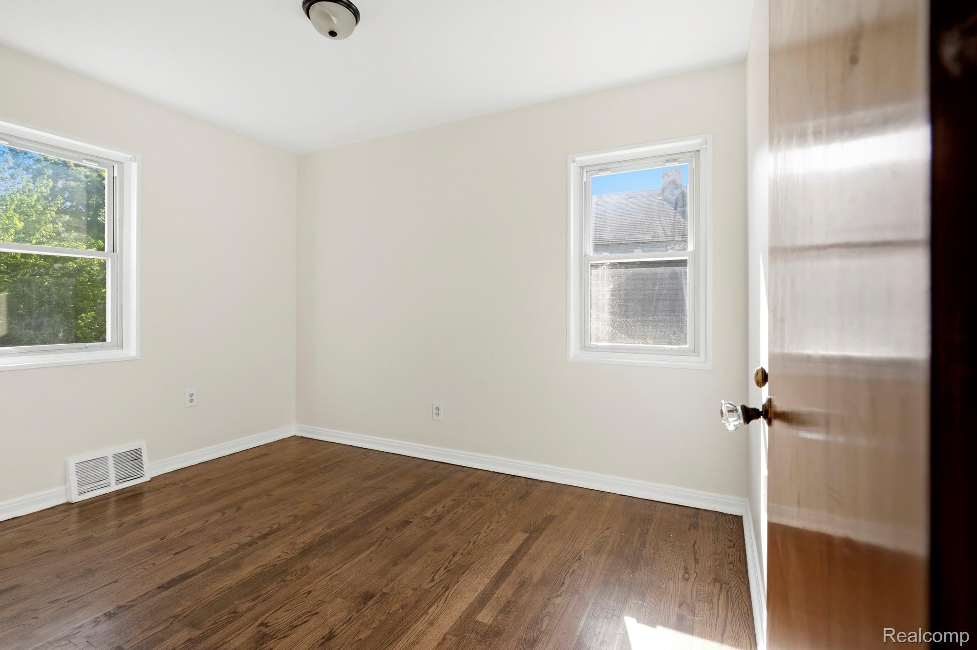 970 Champaign Road Lincoln Park, MI 48146 - Photo 19 of 28 Spare room featuring baseboards and dark wood-style floors