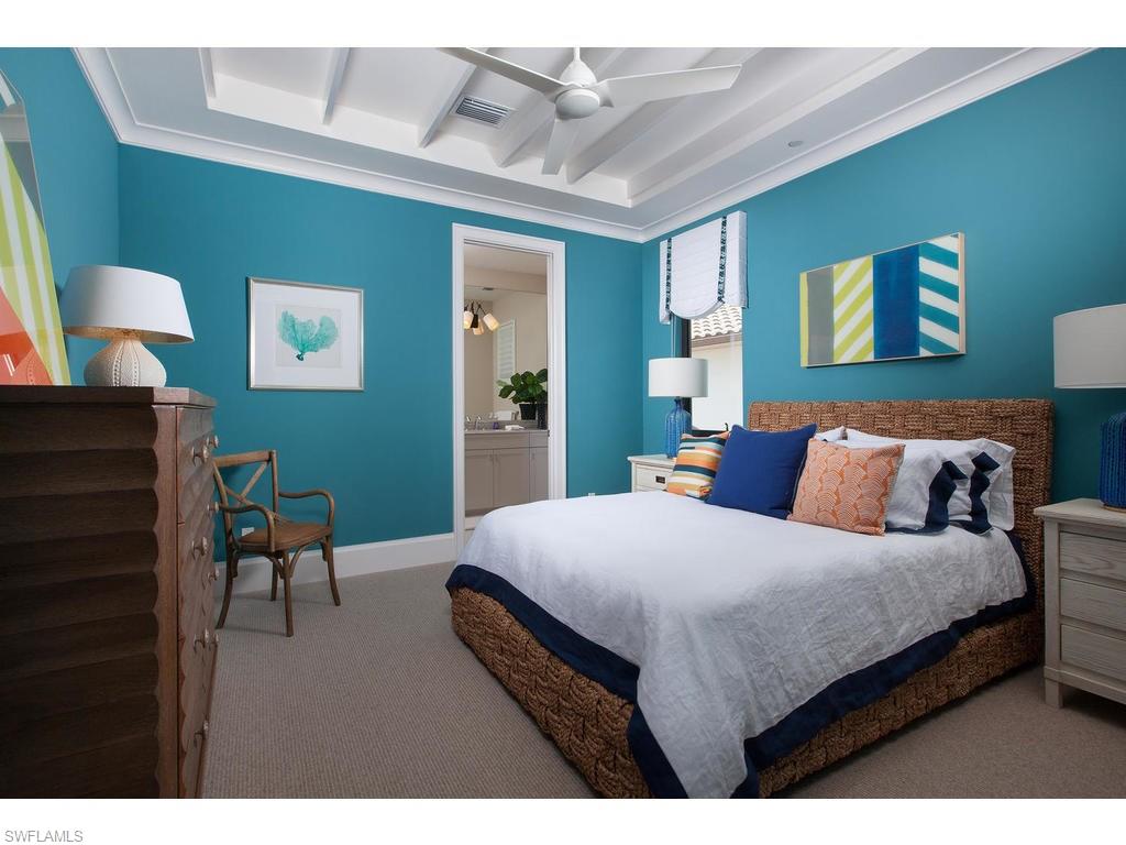 16476 Talis Park Drive Naples, FL 34110 - Photo 14 of 16 a bedroom with a bed and a chair