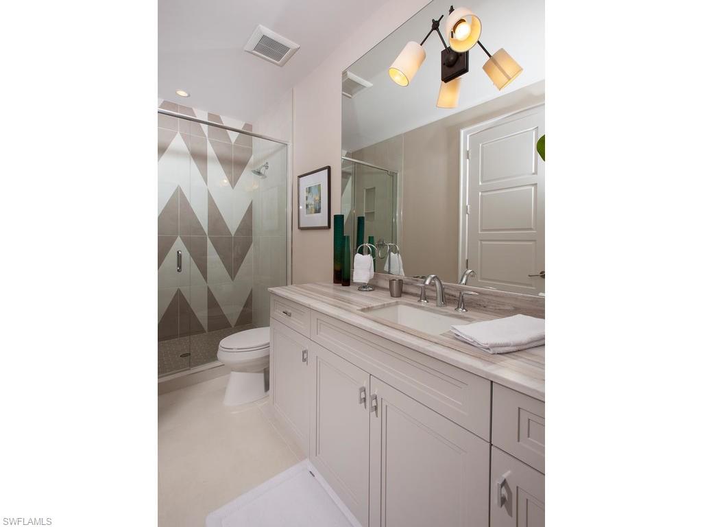 16476 Talis Park Drive Naples, FL 34110 - Photo 15 of 16 a bathroom with a toilet sink and mirror