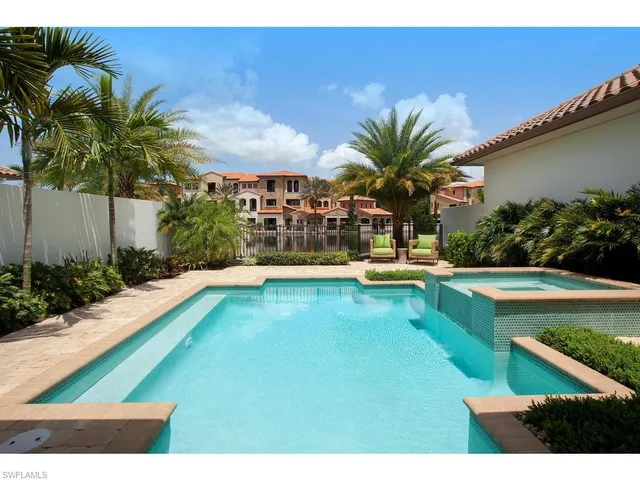 a swimming pool with outdoor seating and yard
