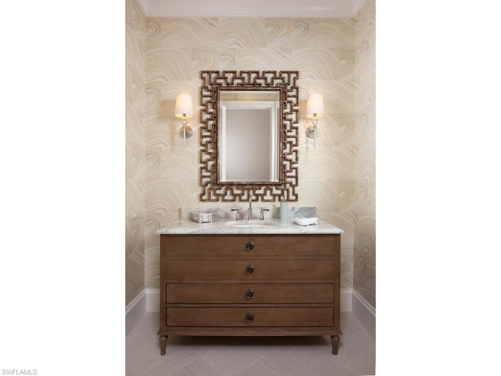 16476 Talis Park Drive Naples, FL 34110 - Photo 7 of 16 a bathroom with a sink and a mirror