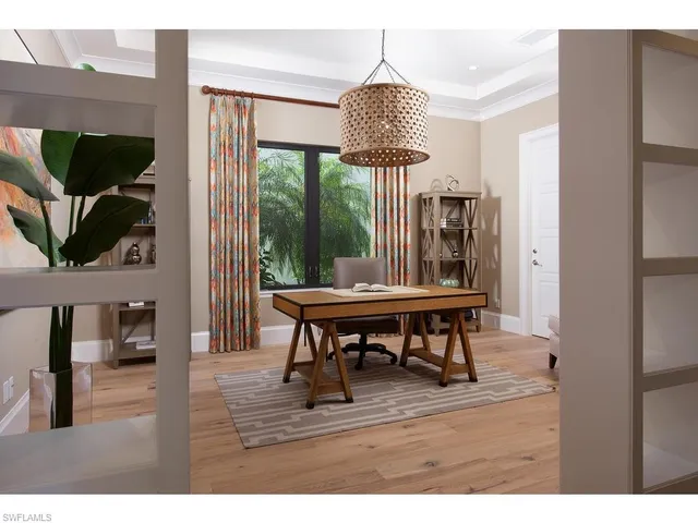 a view of a livingroom with furniture window and wooden floor