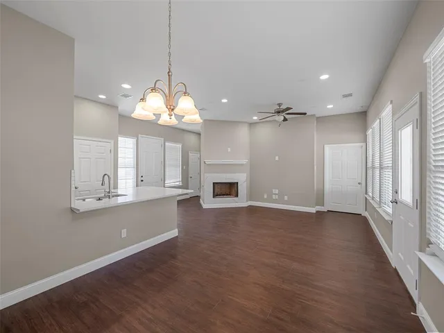 an empty room with wooden floor and fireplace