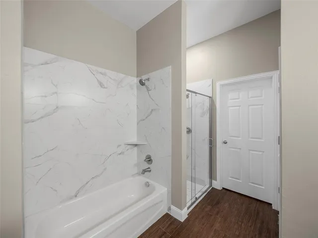 a bathroom with a bathtub and shower