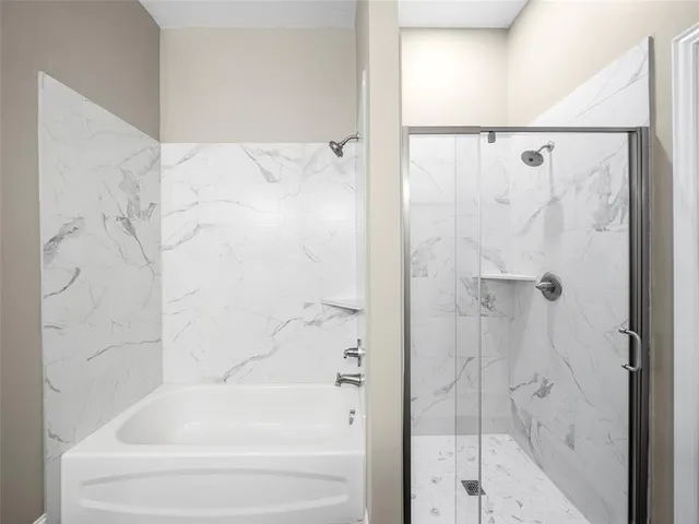 a bathroom with a bathtub and a shower