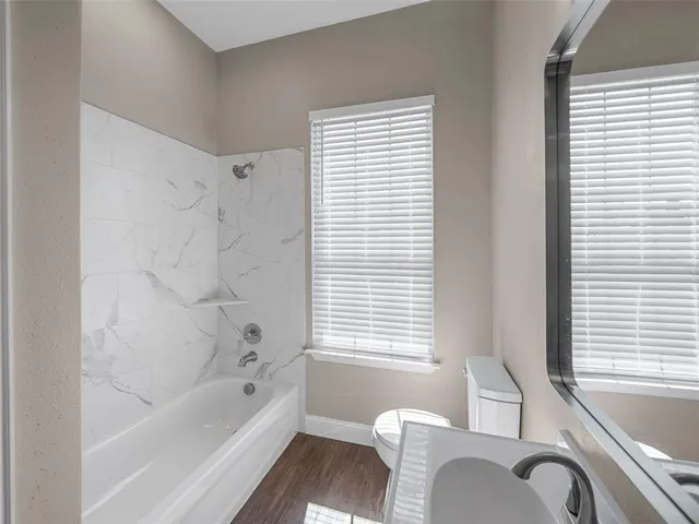 a white bath tub sitting next to a window