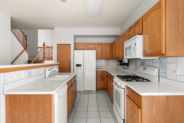 a kitchen with a sink stove top oven and cabinets