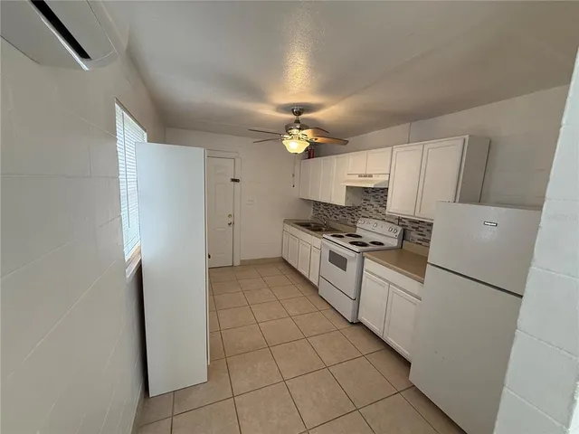 a kitchen with cabinets and appliances