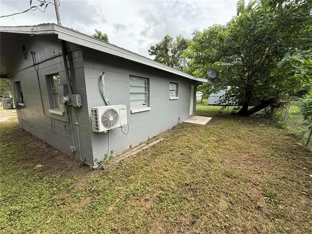 a view of a house with yard and sitting area