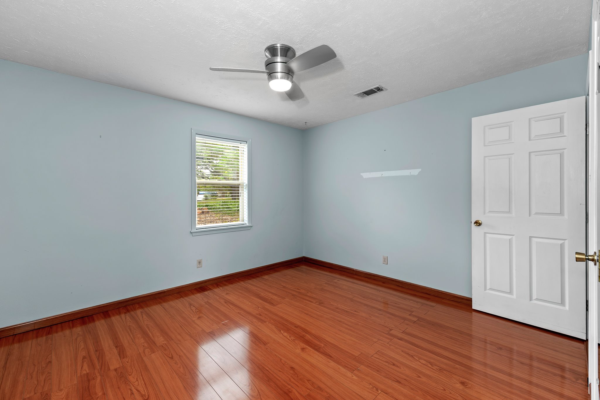5600 Libyan Circle Austin, TX 78745 - Photo 25 of 37 Unfurnished room featuring hardwood / wood-style flooring, ceiling fan, and a textured ceiling