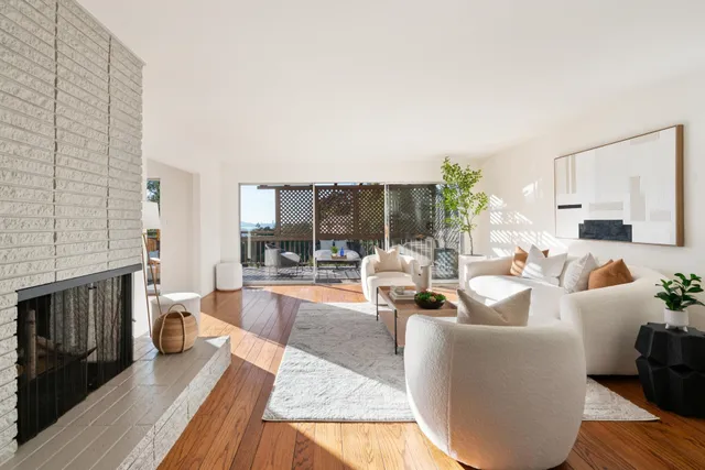 a living room with furniture wooden floor and a fireplace