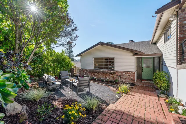 a view of backyard with outdoor seating and green space