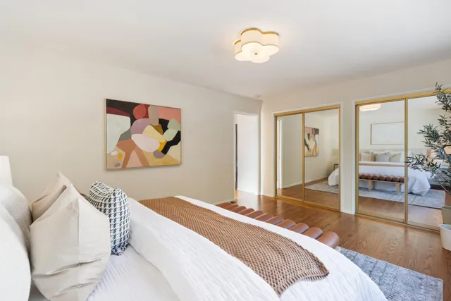 a bedroom with a bed and a chandelier