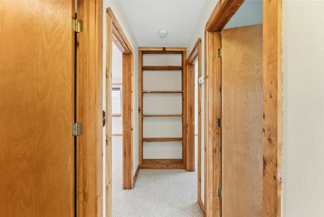 an empty room with windows and cabinet
