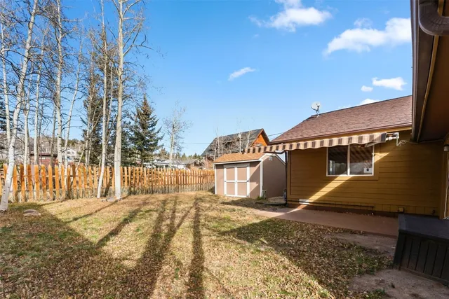 a view of a house with wooden fence