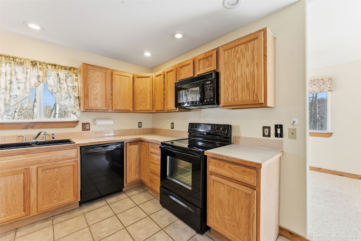 316 3rd Street Fairplay, CO 80440 - Photo 8 of 37 a kitchen with stainless steel appliances granite countertop a stove a sink and a microwave