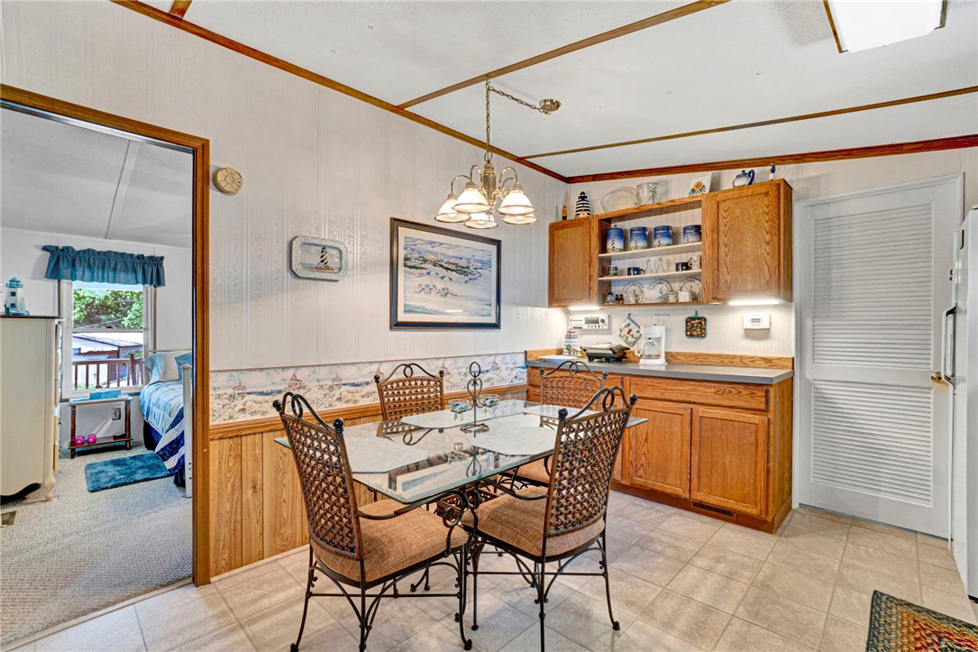 225 Nicholson Cove Road Seneca, SC 29672 - Photo 15 of 22 A well-lit dining area offers a cozy space for meals, complemented by functional cabinetry and convenient access to the adjoining bedroom.