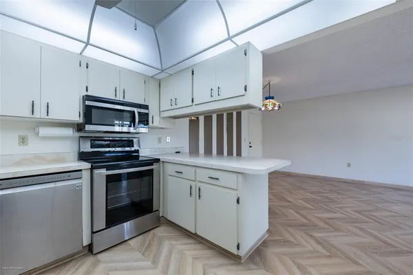 a kitchen with granite countertop a stove sink and cabinets