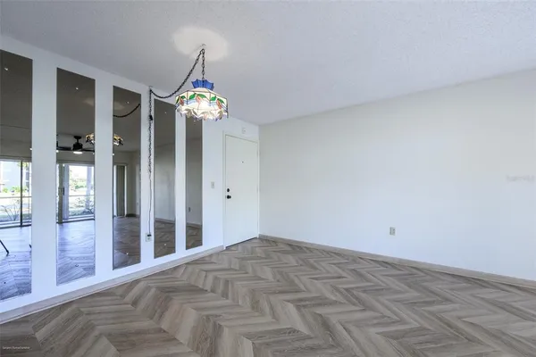 a view of a chandelier fan and entryway