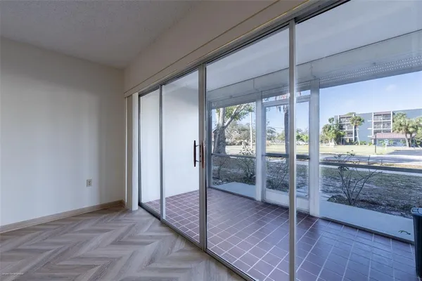 a view of empty room with wooden floor