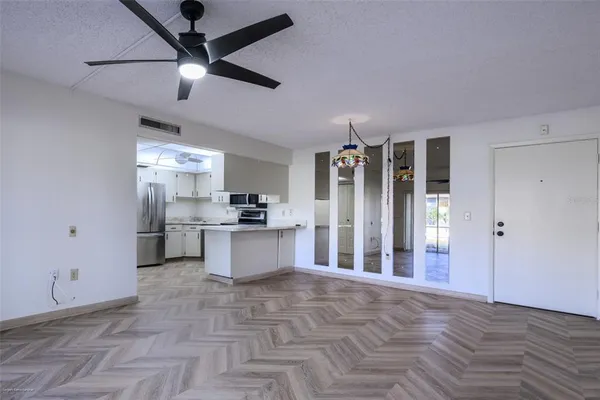 a large kitchen with granite countertop a refrigerator and a stove top oven