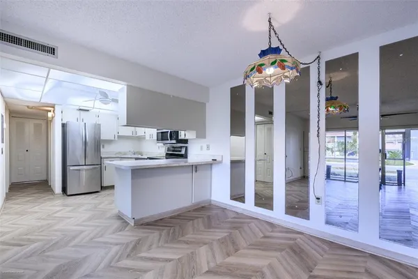 a kitchen with stainless steel appliances granite countertop a refrigerator and a sink